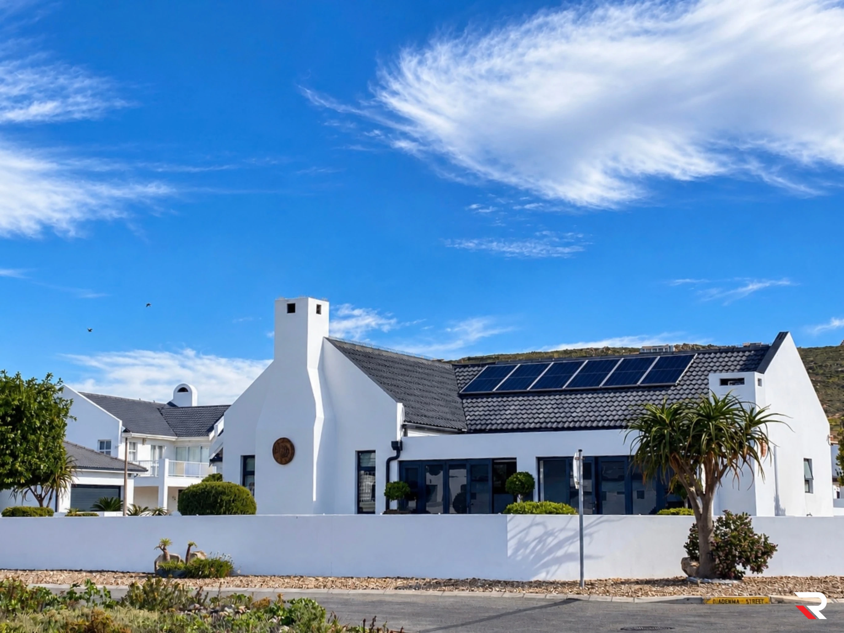 Second completed white residential building with solar panels